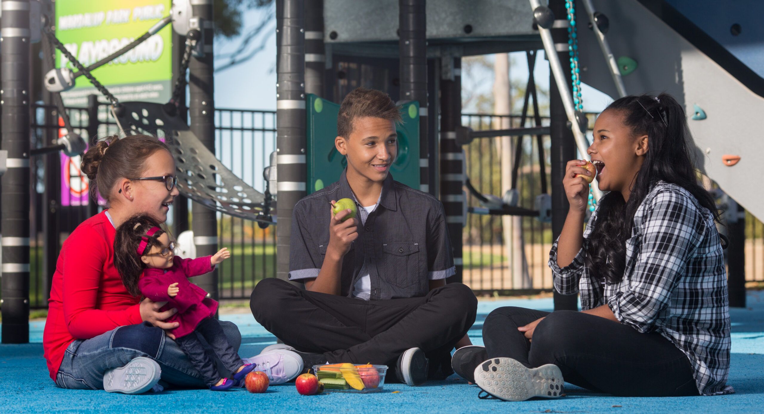 Children eating fruit in playground